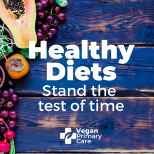 Photo showing healthy fruit and vegetables on a rustic wooden tabletop with the words “healthy Diets stand the test of time” and below is the logo for veganprimarycare.com