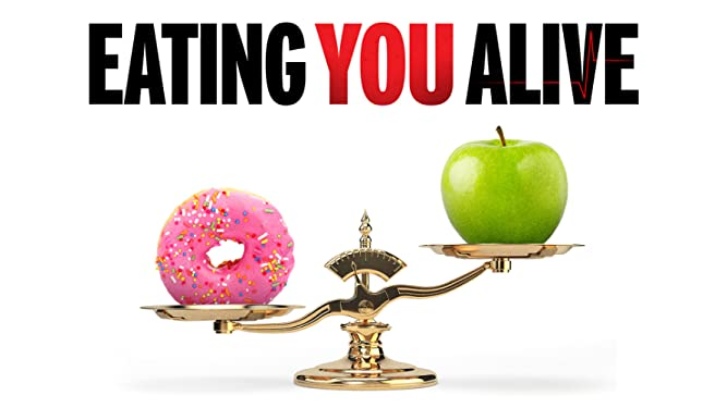 Movie poster for vegan movie eating you alive showing a classic weight scale with a doughnut and an apple with the apple raised up