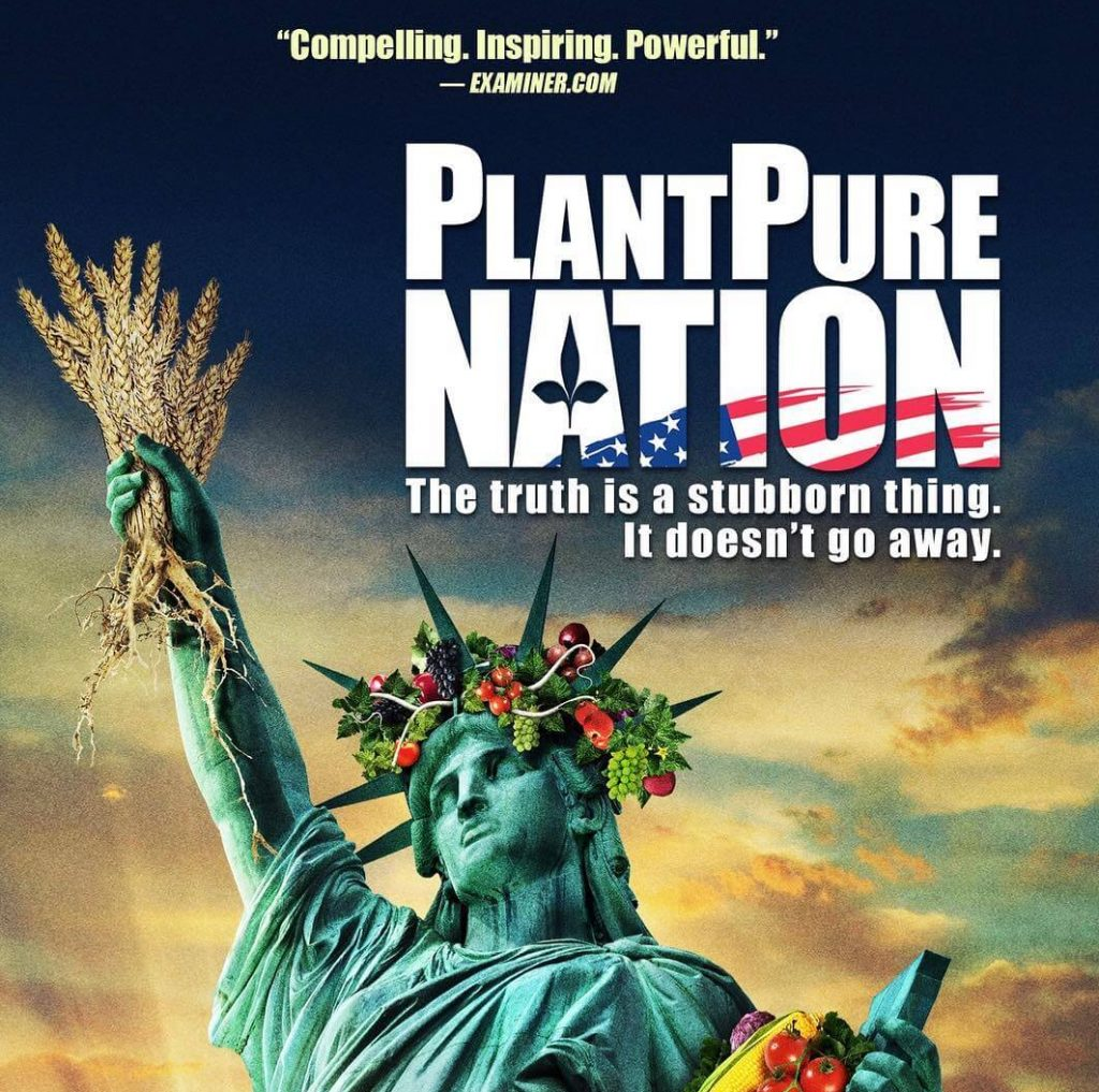 A vegan Movie poster for PlantPure Nation showing a statue of liberty holding grain instead of a torch and she is adorned with fruits and flowers