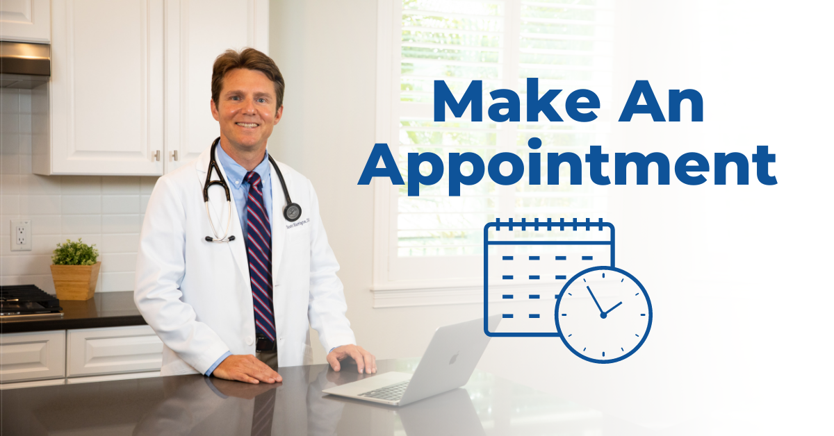 Picture of Dr. Scott Harrington DO standing by his computer with sign that says make an appointment with a symbol of a calendar and clock